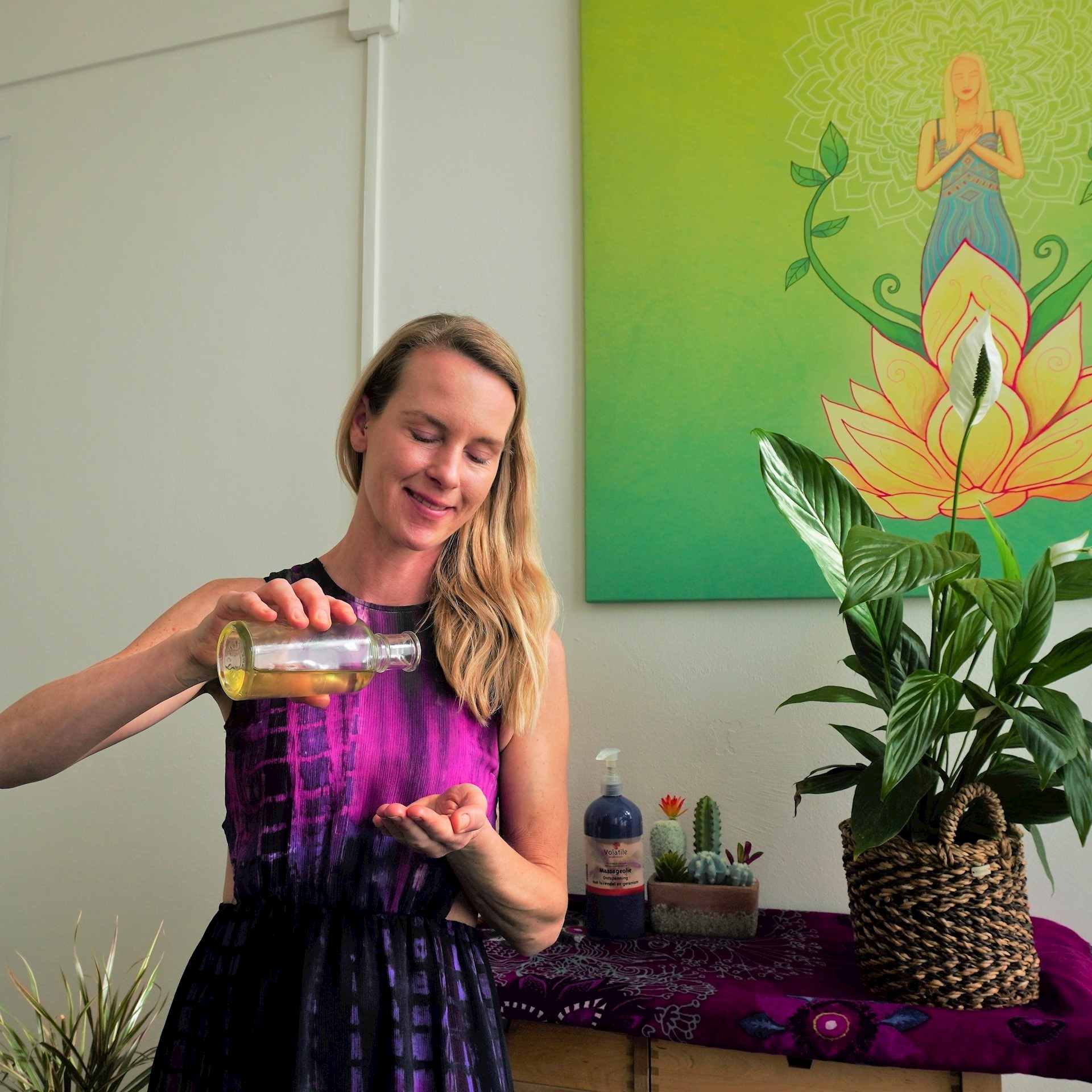 Jannet Veenbaas giet olie in haar hand voor een holistische massage 